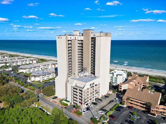 drone / aerial view featuring a water view and a beach view