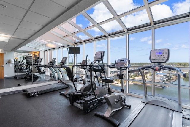 gym with a drop ceiling and expansive windows