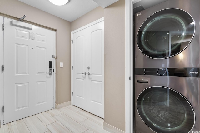 washroom with stacked washer and clothes dryer