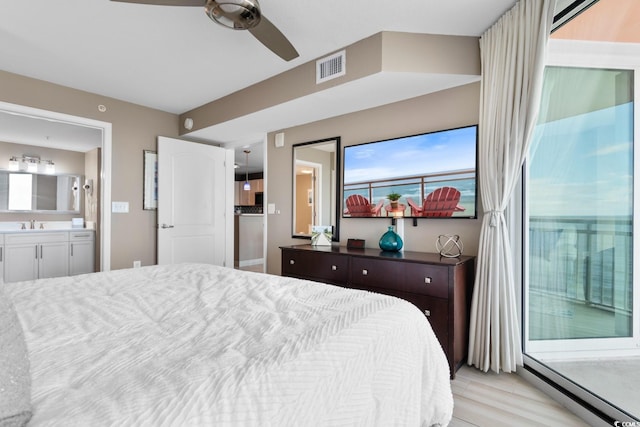 bedroom with connected bathroom, light hardwood / wood-style floors, and ceiling fan