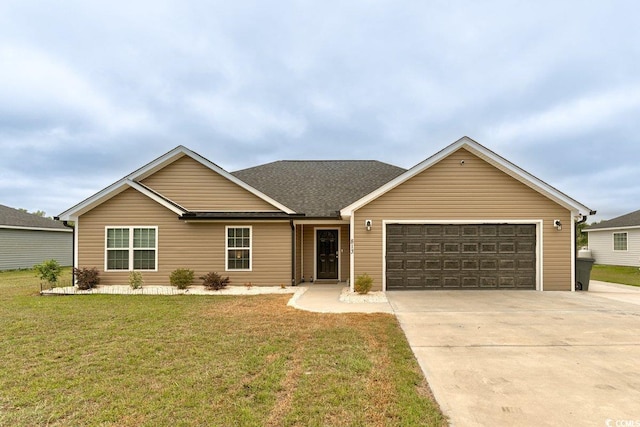 ranch-style house featuring a garage and a front lawn