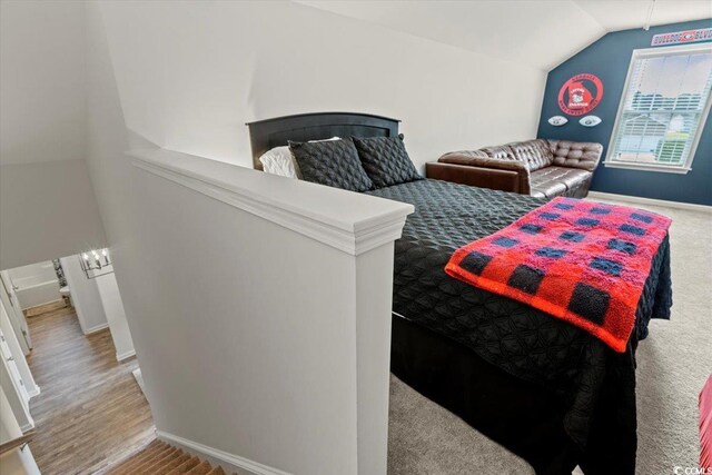 bedroom featuring vaulted ceiling and light hardwood / wood-style flooring