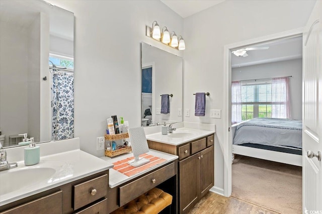 ensuite bathroom featuring ensuite bathroom, a shower with shower curtain, and vanity