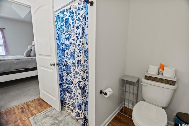 full bathroom featuring a shower with curtain, toilet, ensuite bath, and wood finished floors