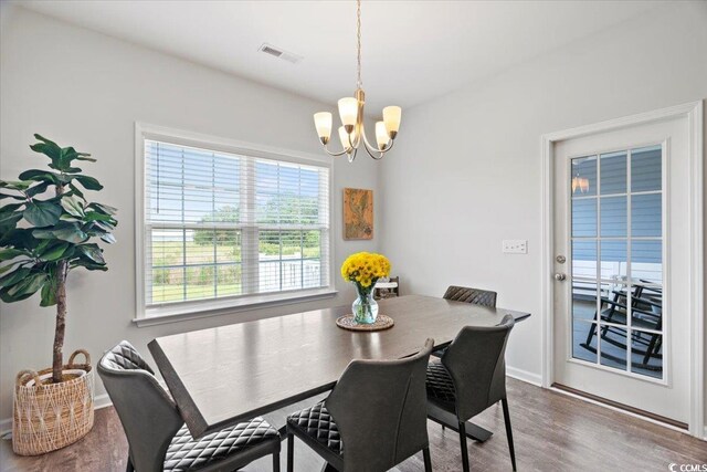 dining area featuring a notable chandelier and hardwood / wood-style flooring