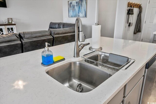 kitchen with sink and light stone counters