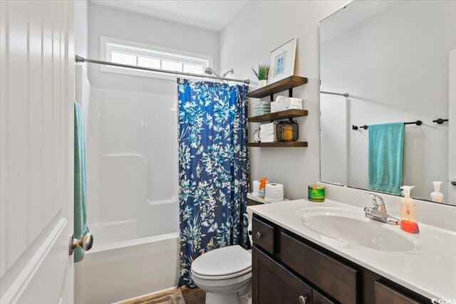 full bathroom featuring shower / tub combo, vanity, and toilet