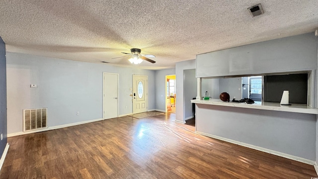 interior space featuring wood-type flooring, a textured ceiling, and ceiling fan