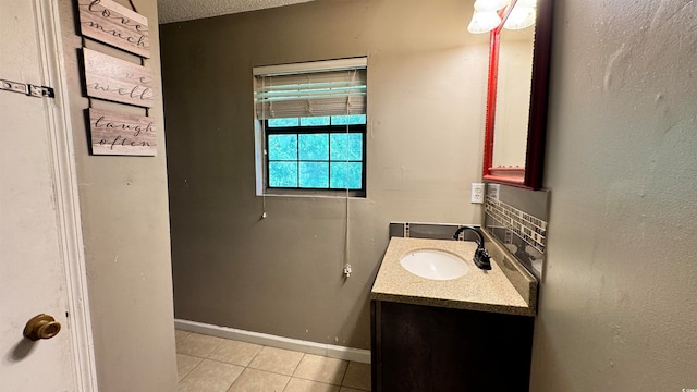 bathroom with tile patterned flooring, vanity, and decorative backsplash