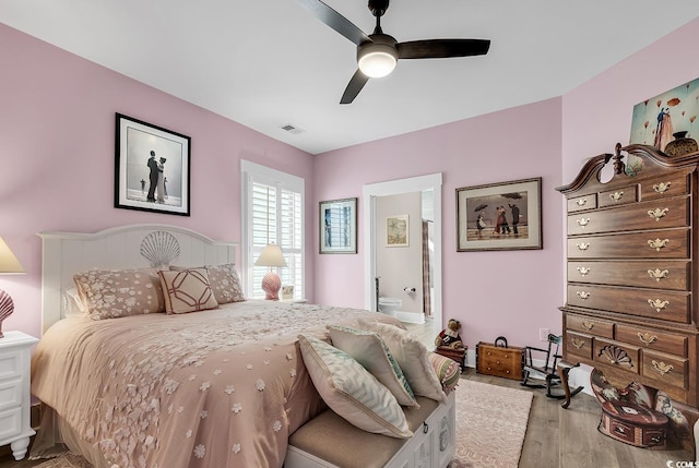 bedroom with light hardwood / wood-style floors, connected bathroom, and ceiling fan