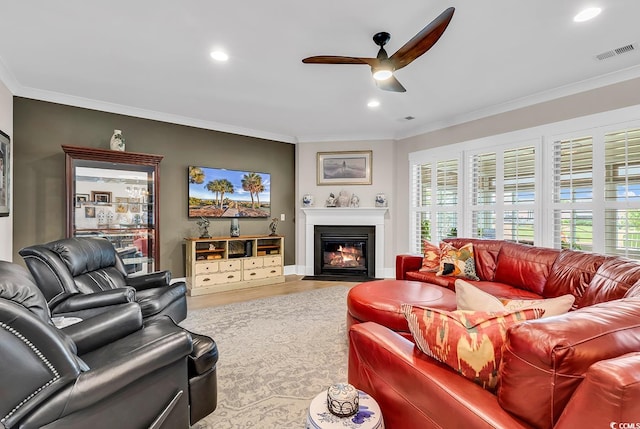 living room featuring crown molding, ceiling fan, and hardwood / wood-style flooring