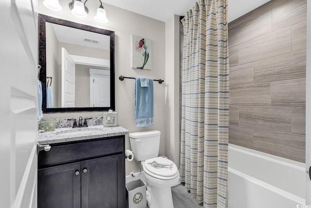 full bathroom featuring shower / tub combo, vanity, and toilet