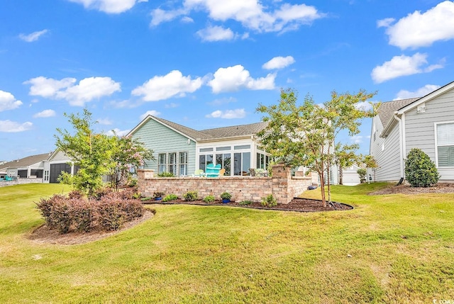 back of house featuring a garage and a lawn