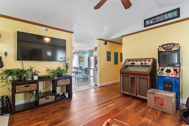 interior space featuring ornamental molding, a textured ceiling, ceiling fan, and dark hardwood / wood-style flooring