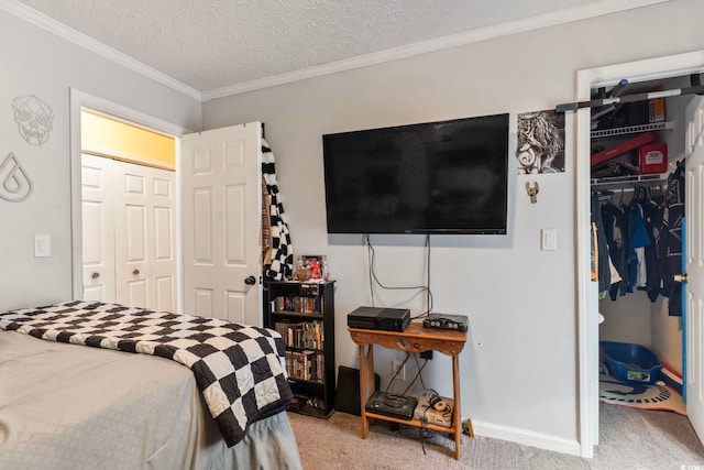 carpeted bedroom featuring a textured ceiling, a closet, and ornamental molding