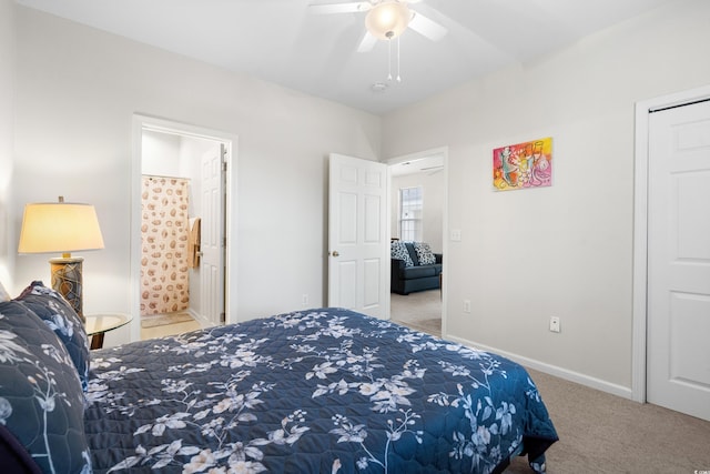 carpeted bedroom featuring ceiling fan and ensuite bathroom