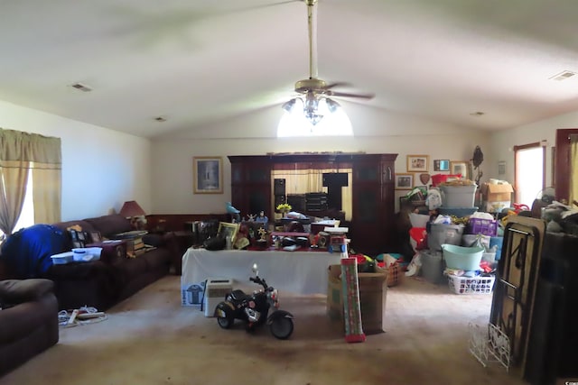 living room featuring vaulted ceiling, light carpet, and ceiling fan