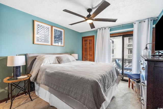 carpeted bedroom featuring ceiling fan, a textured ceiling, and a closet