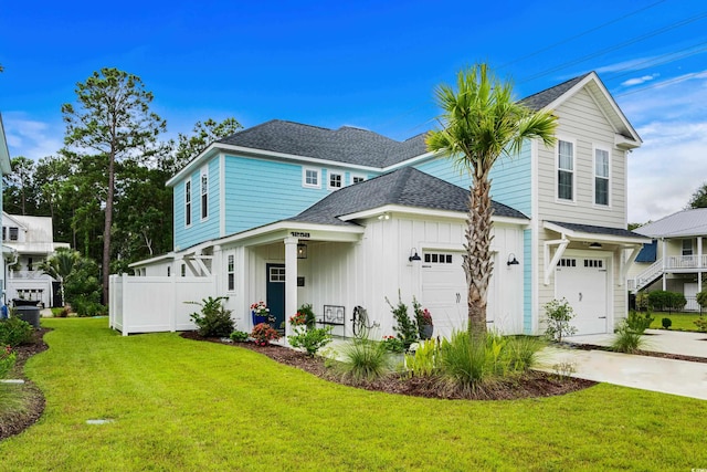 view of front property featuring a garage and a front yard