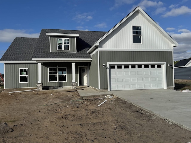 view of front facade with covered porch and a garage