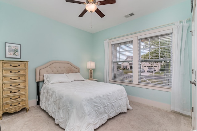 bedroom featuring light carpet, baseboards, visible vents, and a ceiling fan