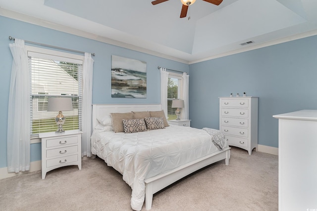 bedroom with multiple windows, ornamental molding, ceiling fan, and light colored carpet