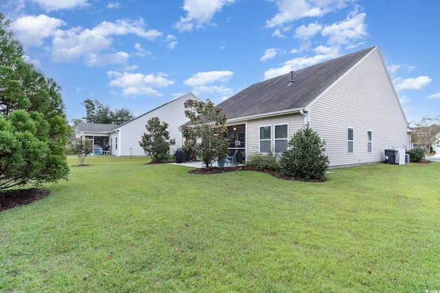exterior space with a sunroom and a yard