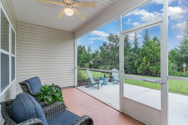 unfurnished sunroom with wood ceiling and ceiling fan