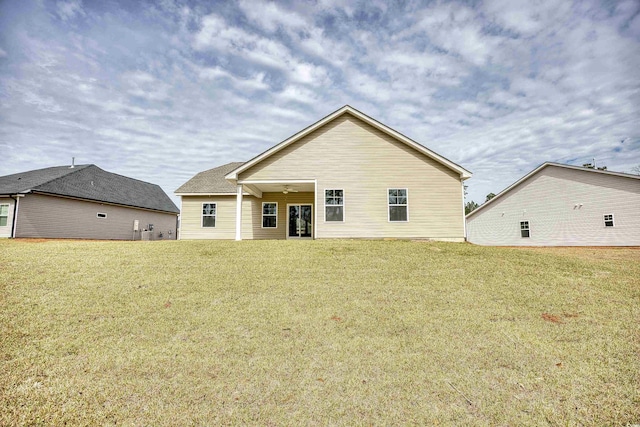 back of house featuring a yard