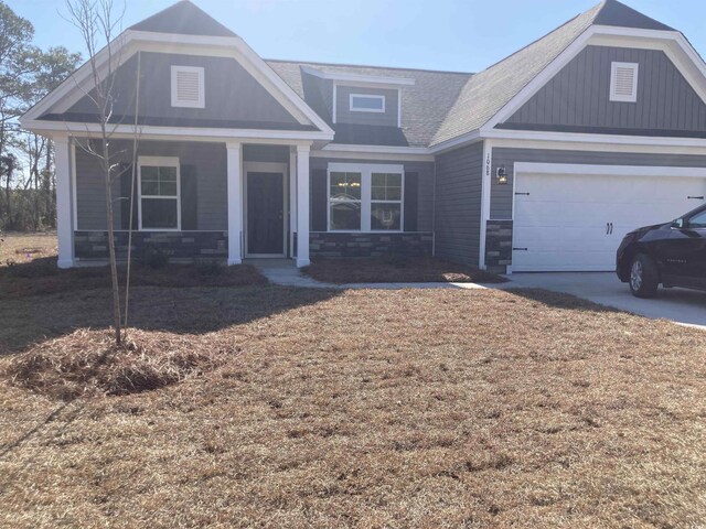 craftsman-style home with a garage and a porch