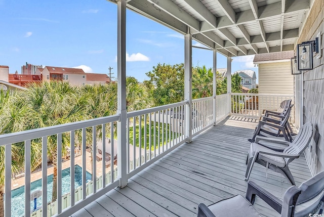 wooden deck with a fenced in pool