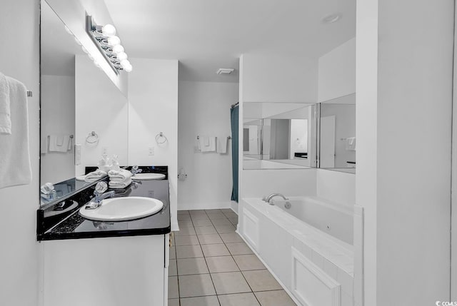 bathroom with tile patterned flooring, a bath, and vanity