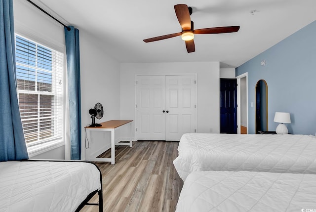 bedroom featuring light hardwood / wood-style flooring, a closet, and ceiling fan