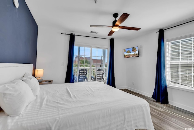 bedroom featuring ceiling fan, hardwood / wood-style flooring, and access to exterior