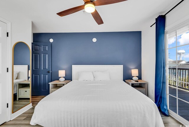 bedroom featuring ceiling fan, hardwood / wood-style flooring, and access to exterior