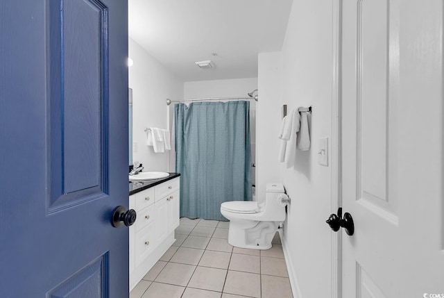 bathroom featuring walk in shower, vanity, tile patterned flooring, and toilet