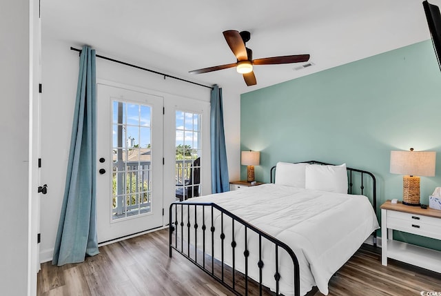 bedroom featuring ceiling fan, access to outside, and dark wood-type flooring