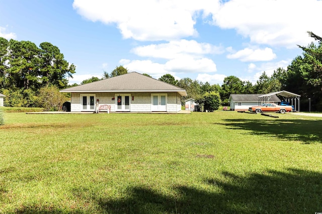 exterior space featuring french doors, a front yard, and a carport