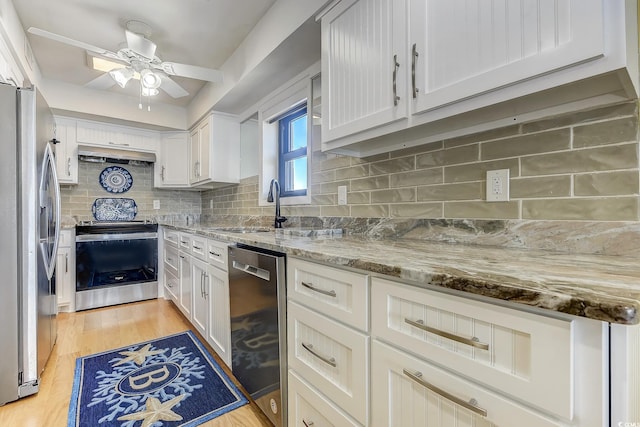 kitchen featuring ceiling fan, appliances with stainless steel finishes, light wood-type flooring, and white cabinetry