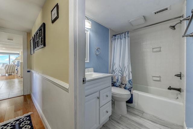 full bathroom with vanity, shower / tub combo with curtain, toilet, and hardwood / wood-style flooring