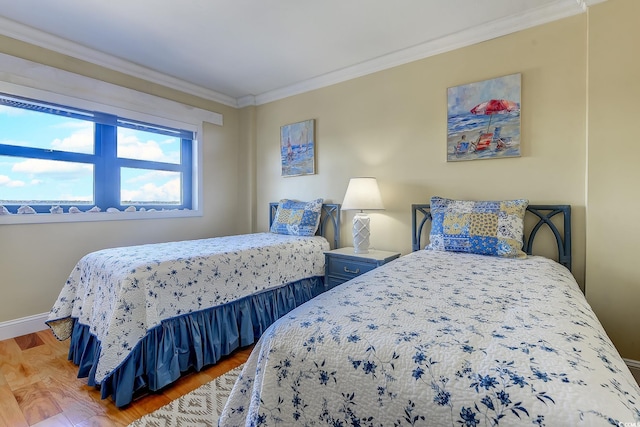 bedroom with ornamental molding and hardwood / wood-style floors