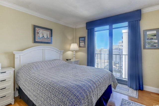 bedroom with ornamental molding and light hardwood / wood-style floors