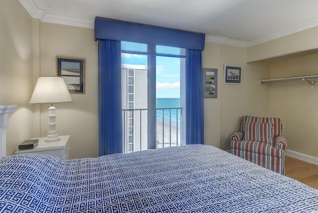 bedroom with ornamental molding, a closet, and hardwood / wood-style flooring