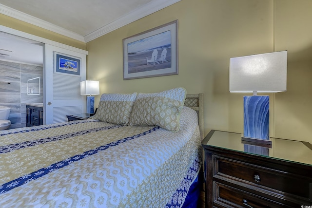 bedroom featuring connected bathroom and ornamental molding