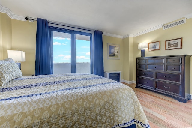 bedroom featuring light hardwood / wood-style flooring, access to exterior, and crown molding