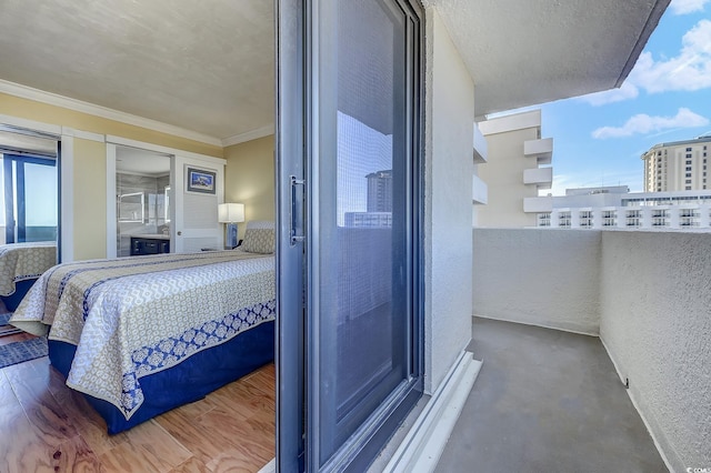 bedroom featuring crown molding and concrete flooring