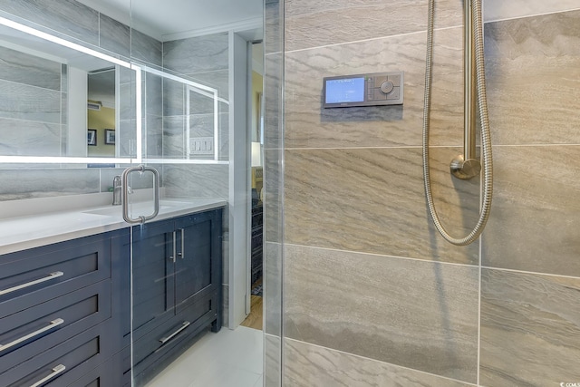 bathroom featuring tile walls, vanity, and tiled shower