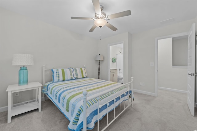 bedroom with light colored carpet, ceiling fan, and ensuite bathroom