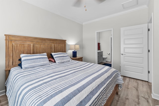 bedroom with ornamental molding, connected bathroom, light hardwood / wood-style floors, and ceiling fan