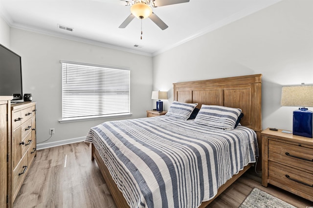 bedroom featuring ornamental molding, ceiling fan, and light hardwood / wood-style flooring